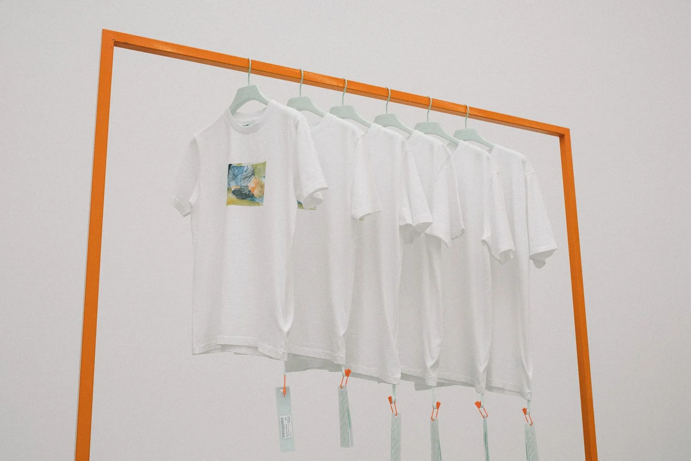 A rail of Off-White and Lucien Smith T-shirts in the EM PTY GALLERY