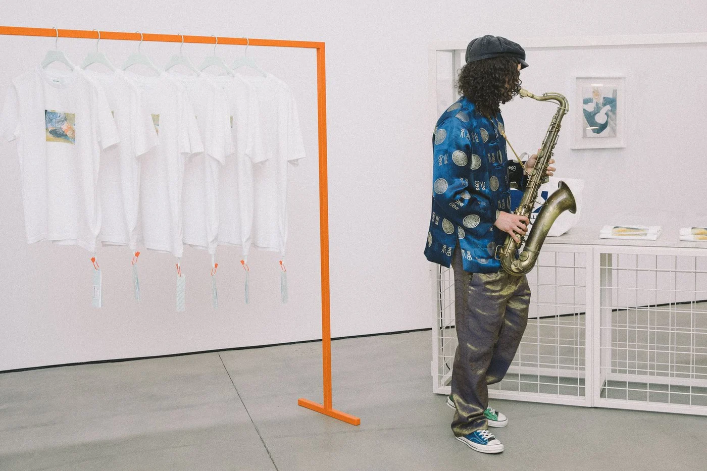 A member of Onyx Collective warming up beside the T-shirt rail