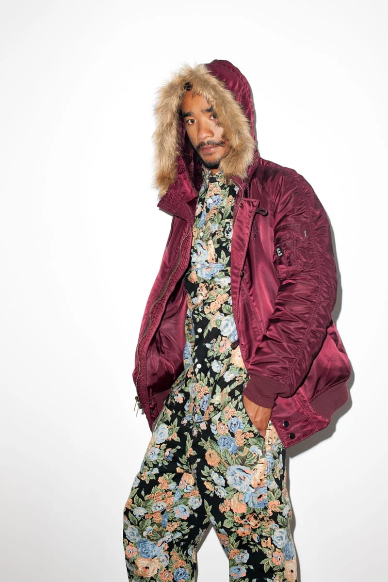 Lucien Smith in a burgundy parka over a floral outfit for the SENSE Supreme Fall/Winter 2014 editorial