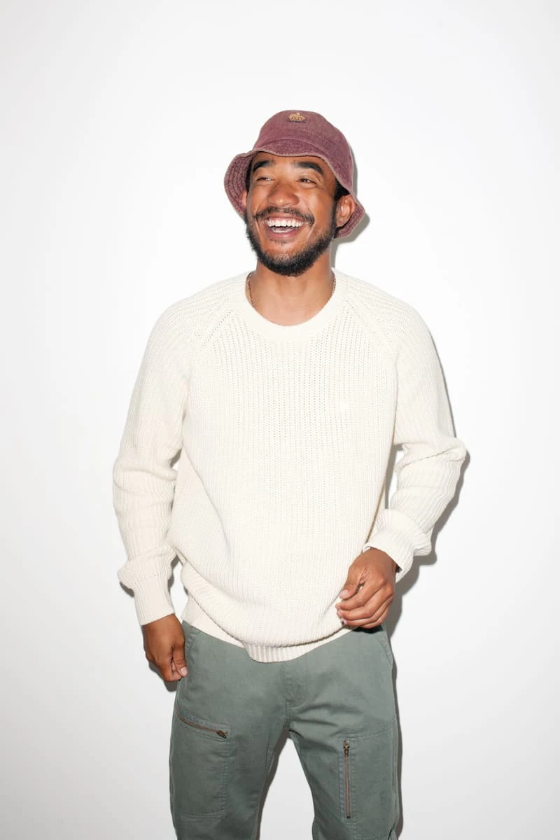 Lucien Smith in a white knit sweater and burgundy bucket hat for the SENSE Supreme Fall/Winter 2014 editorial