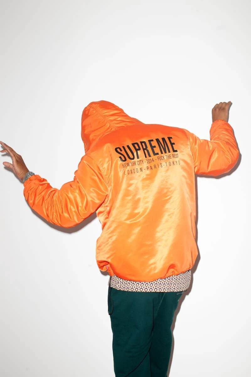 Rear view of Lucien Smith wearing an orange Supreme jacket for the SENSE Supreme Fall/Winter 2014 editorial