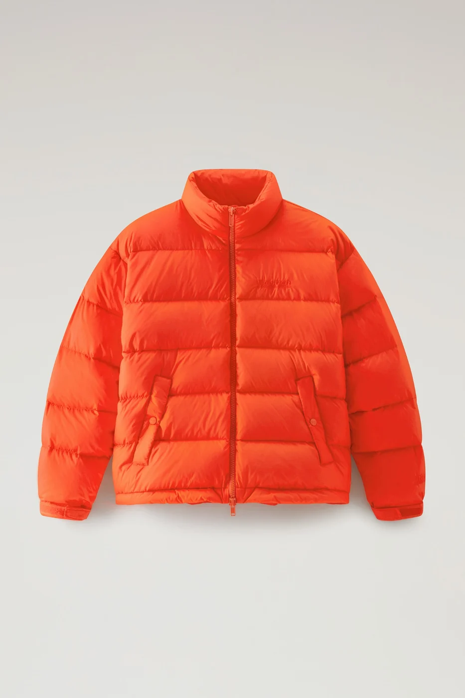 Orange down jacket from the Woolrich by Serving the People collection